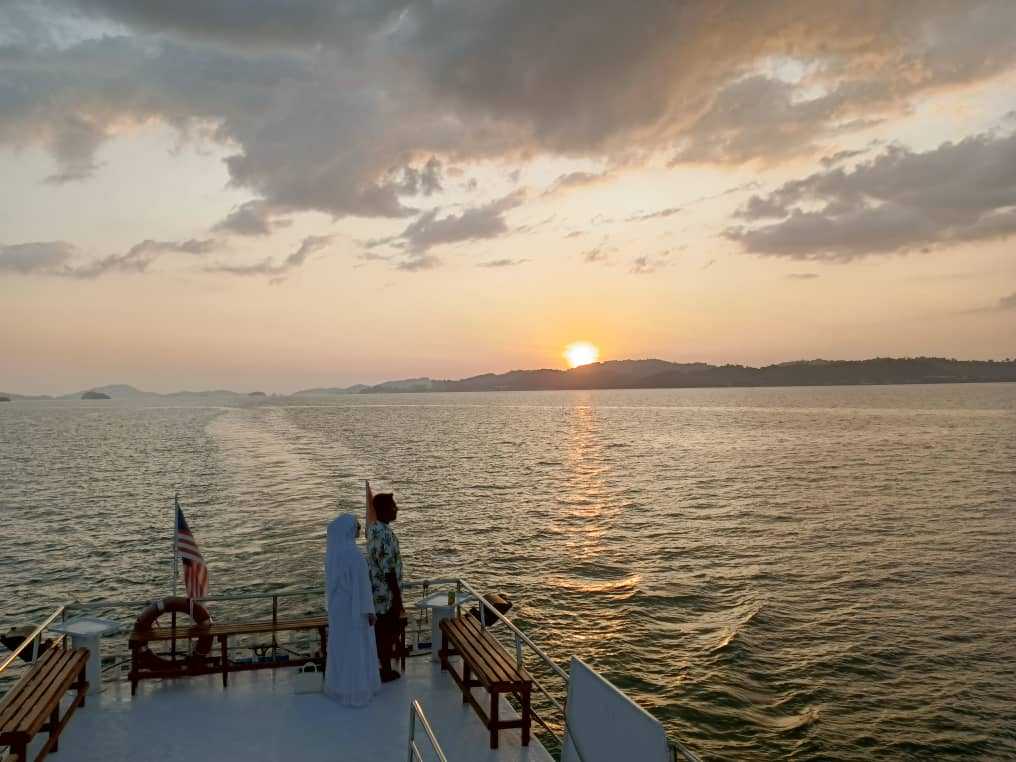 Couple enjoying sunset view on Langkawi halal sunset cruise